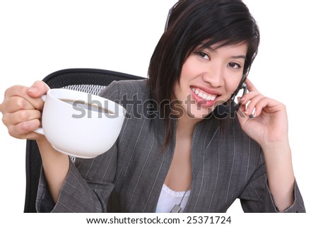 An attractive asian business woman in office drinking coffee