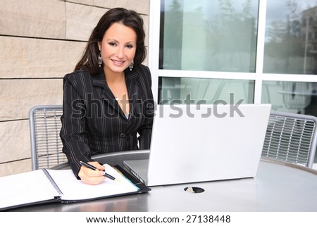 A pretty business woman on laptop computer at office