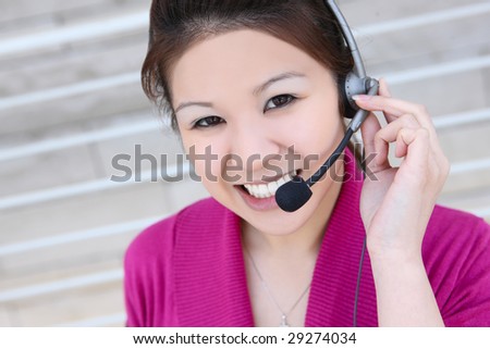 An asian customer service employee thinking and listening to the client