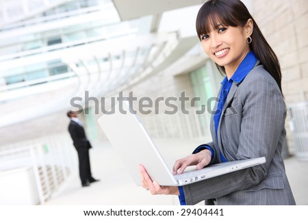 A young pretty asian business woman on laptop computer at work
