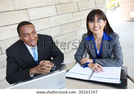 A young diverse business man and woman  team on laptop computer at work