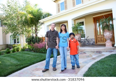 Attractive diverse happy family outside their home
