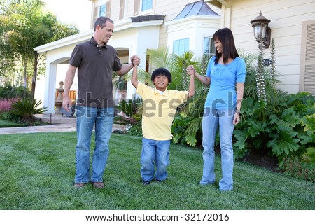 Attractive diverse family outside their home on porch