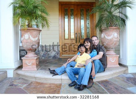 Attractive diverse family outside their home on porch