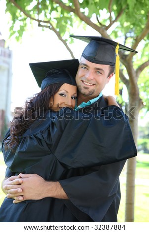 A man and woman couple hugging at college graduation