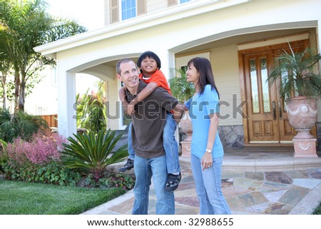 Attractive diverse family outside their home having fun