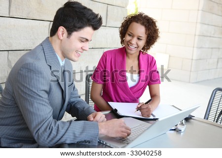 Attractive diverse man and woman business team at work on computer