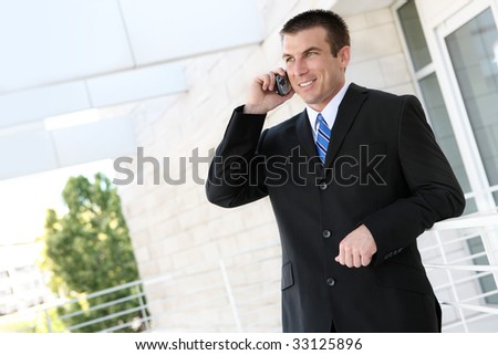 A handsome business man on phone at the office building