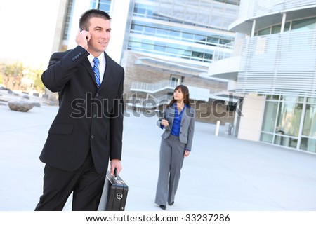 An attractive business man on phone at office building
