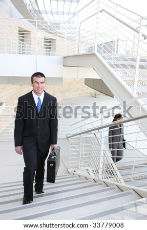 An attractive, young business man on stairs at office building