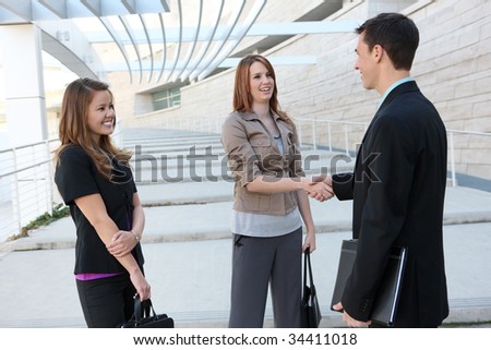 Attractive man and woman business team shaking hands