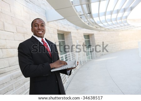 A handsome african business man on laptop computer at office building