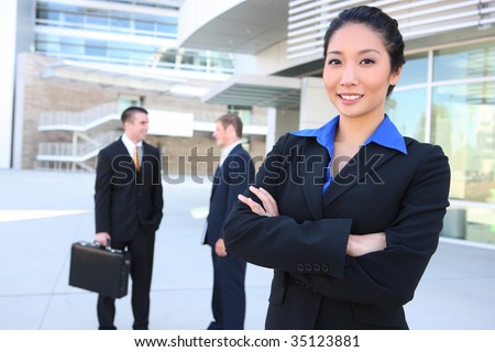 An attractive business team at the office with woman in front