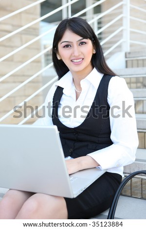 Pretty Business Woman on Stairs with Laptop Computer