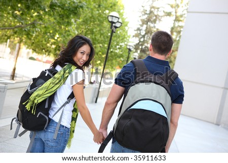 A young man and woman couple in love at the school library