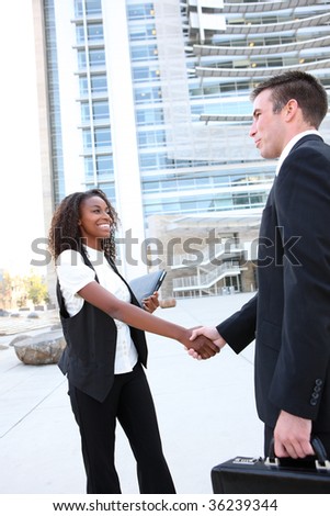 Diverse Man and Woman Business Team shaking hands at office building