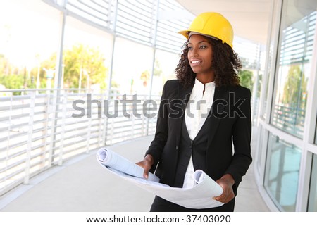 A young pretty woman working as architect on a construction site