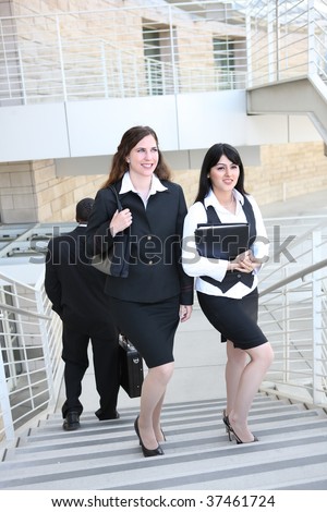Attractive  business woman team walking up stairs to work
