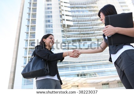 An attractive woman business team shaking hands