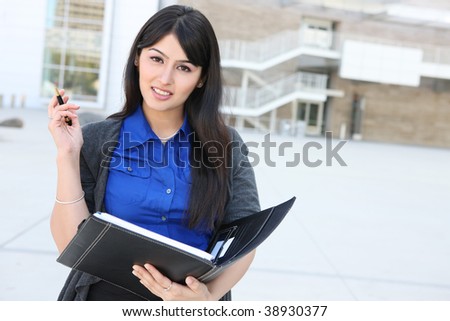 An attractive Indian business woman outside office building