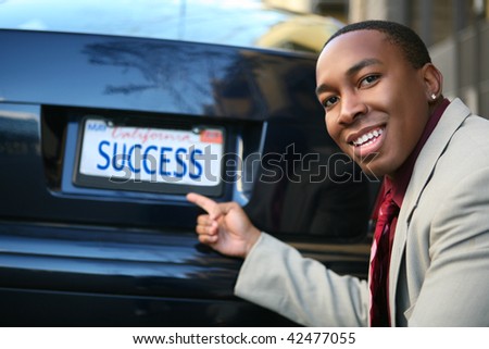 A handsome Business Man with car license plate success (Fictional License Plate)