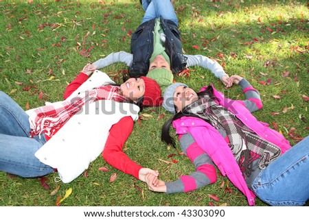 Pretty young asian girls in the park during autumn (fall)