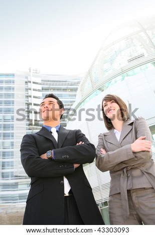 A man and woman business team at their company building