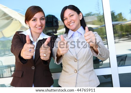 Pretty Business Woman Team at Office Building with Thumbs Up