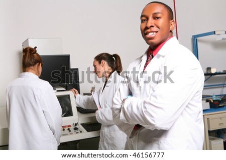 African American Man Computer Technician in Lab with Women Co-Workers