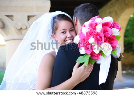 A beautiful bride and hugging groom at church during wedding
