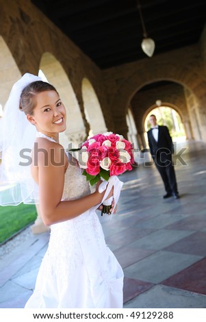 A beautiful woman bride at church during wedding with groom in the background