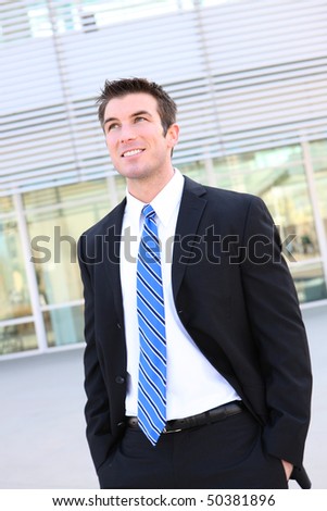 A young handsome business man walking outside office building