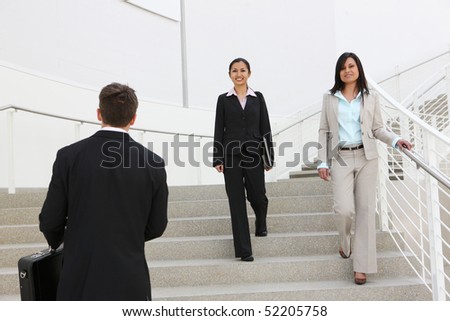 Diverse man and woman workers at the office building on stairs