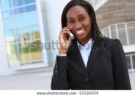 Pretty african business woman on mobile phone at office building