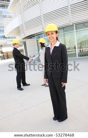 A young attractive man and woman architect team on building construction site with