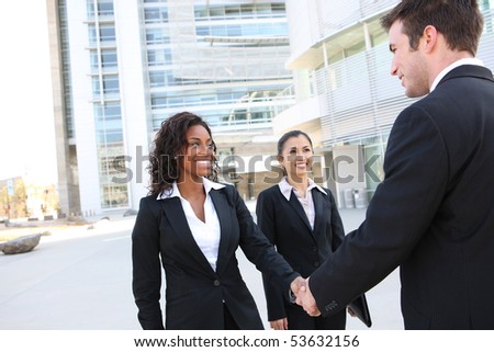 A diverse attractive man and woman business team handshake at office building
