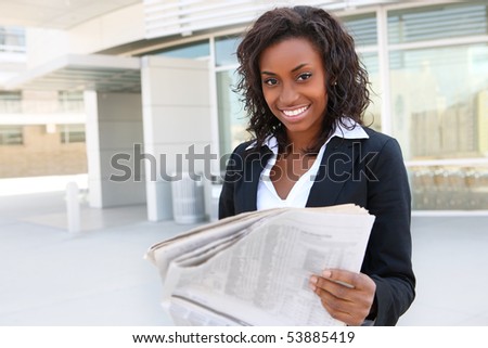 African  business woman reading paper outside office