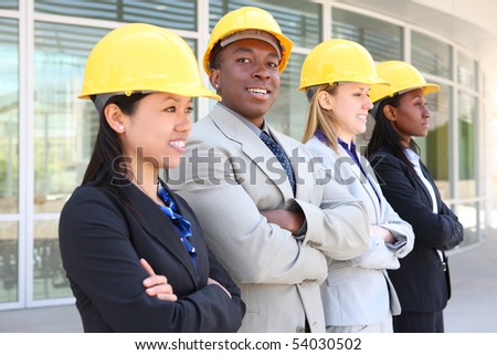An attractive diverse man and woman architect team on construction site