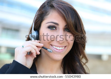 Beautiful business woman on the phone at modern office building