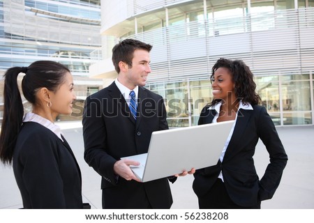 A diverse attractive man and woman business team at office building with laptop computer