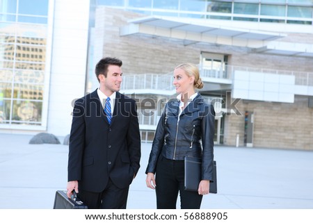 A young attractive business man and woman team at office building