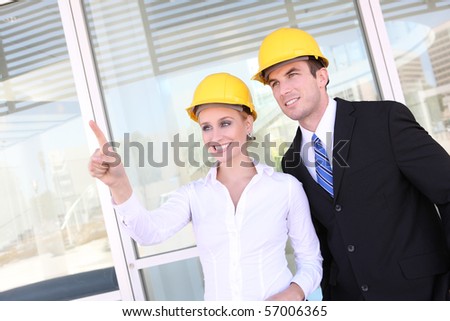 A young attractive man and woman construction team on work site