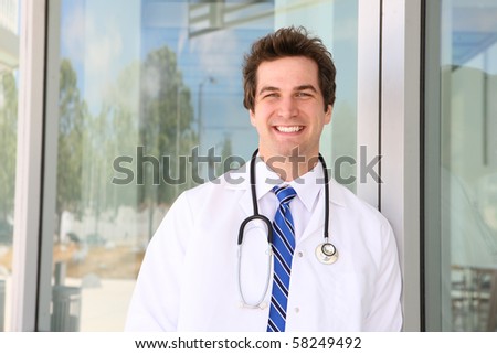 A young handsome man doctor outside hospital building