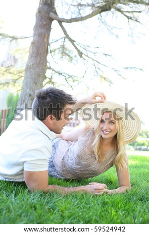 A pretty blonde woman and handsome man in love in the park