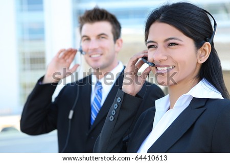 A pretty Indian customer service business woman and caucasian man at office building