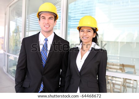 A pretty woman and handsome man architects on building construction site