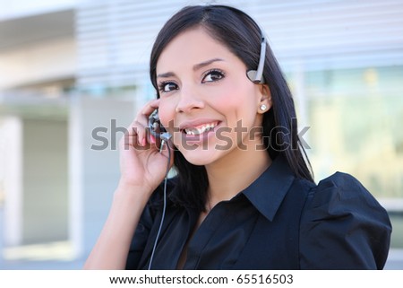 A pretty hispanic customer service business woman on the phone