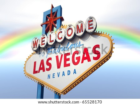 A Las Vegas sign with a beautiful rainbow in the background