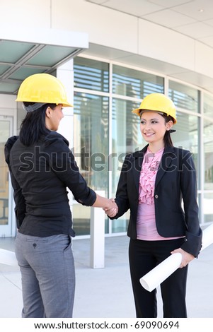 A pretty business women handshake doing construction at office building