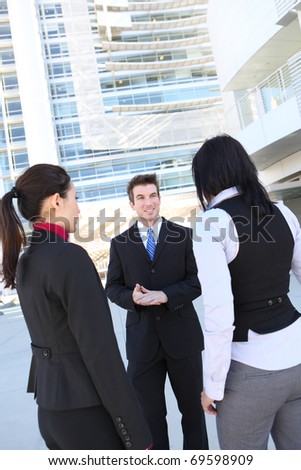 An attractive man and woman business team at office building
